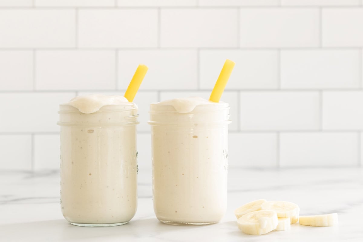 Banana shake in two glasses with straws.