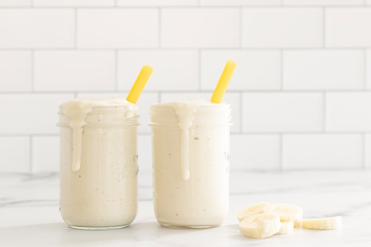 Banana shake in two glasses with straws.