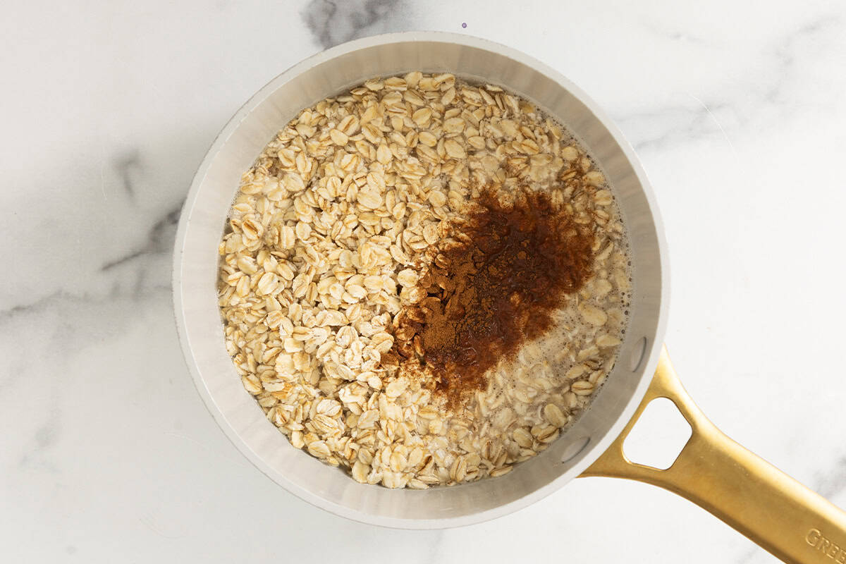 Cinnamon and oats in pot for blueberry oatmeal.