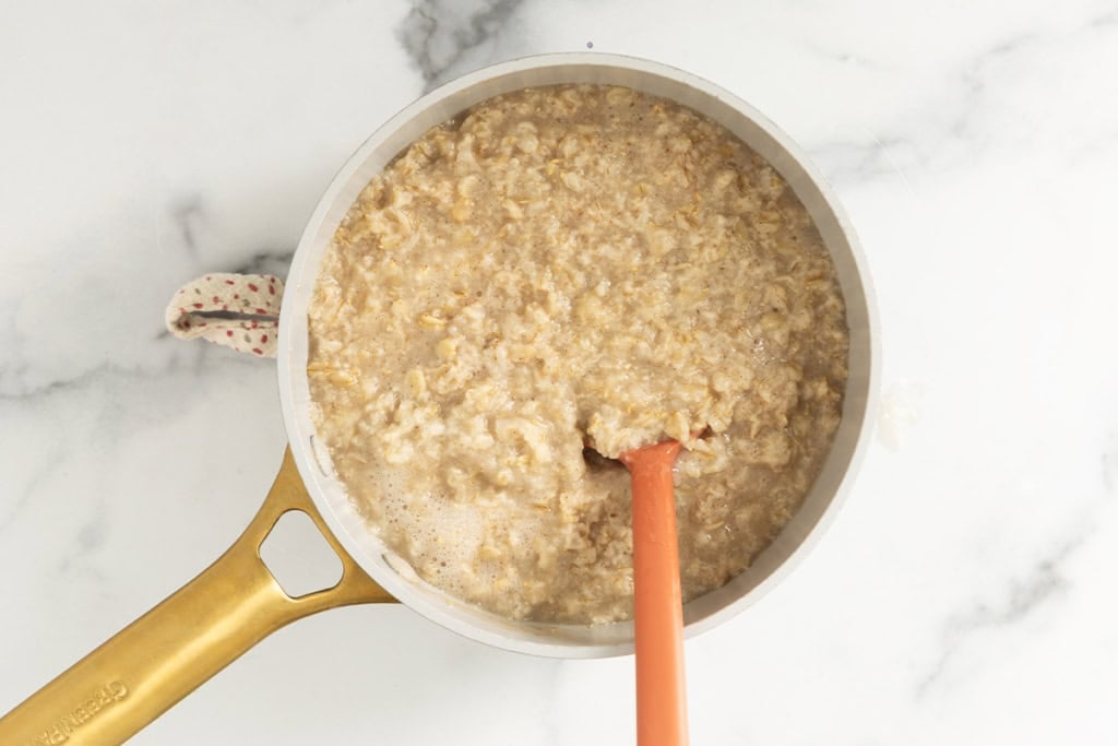 Blueberry Oatmeal in pot with spoon.