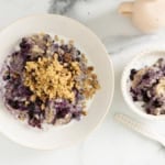Blueberry oatmeal in two bowls with spoons.