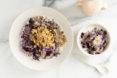 Blueberry oatmeal in two bowls with spoons.