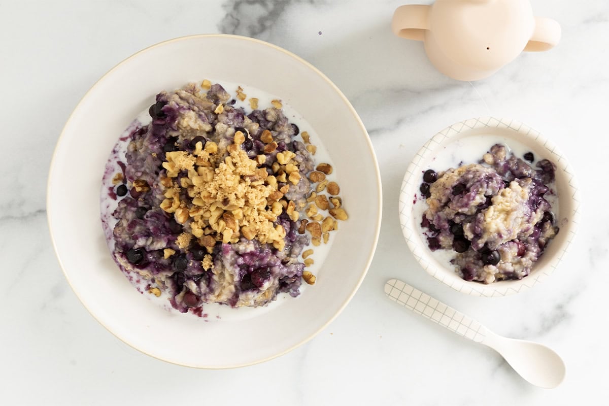 Blueberry oatmeal in two bowls with spoons.