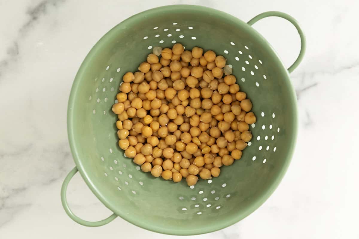 Chickpeas in strainer for chickpea cookie dough.