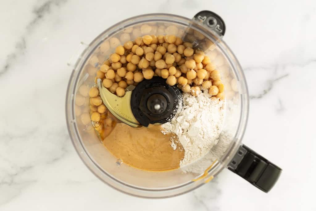Ingredients for chickpea cookie dough in food processor before blending.