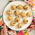 Balls of chickpea cookie dough on white plate.