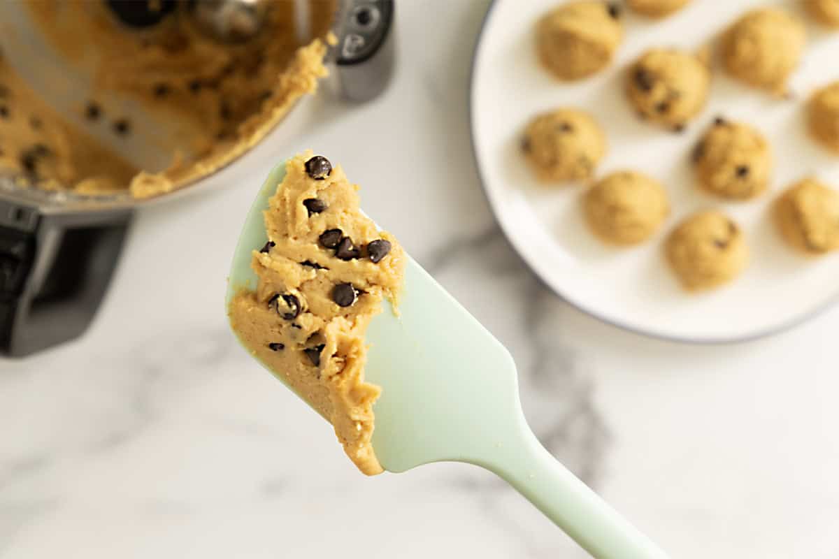 Chickpea cookie dough on blue spatula.