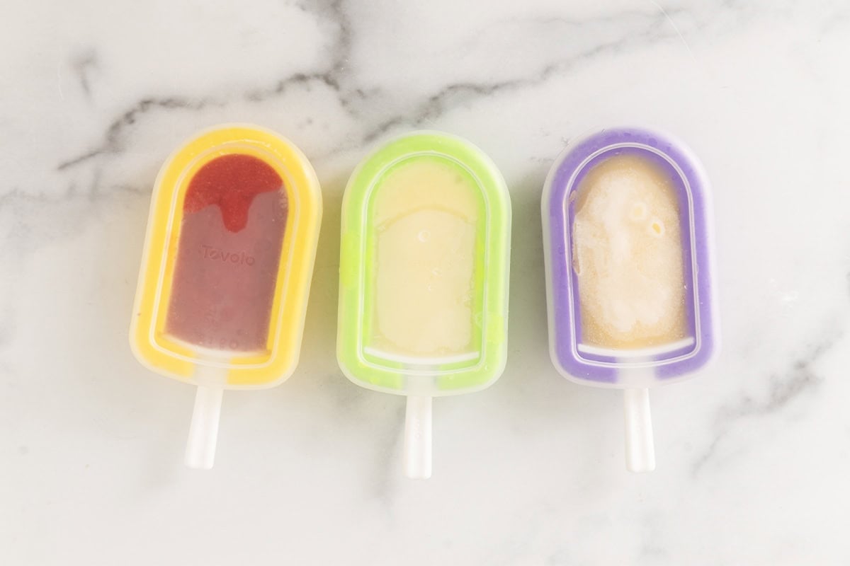 Making frozen fruit bars in molds.