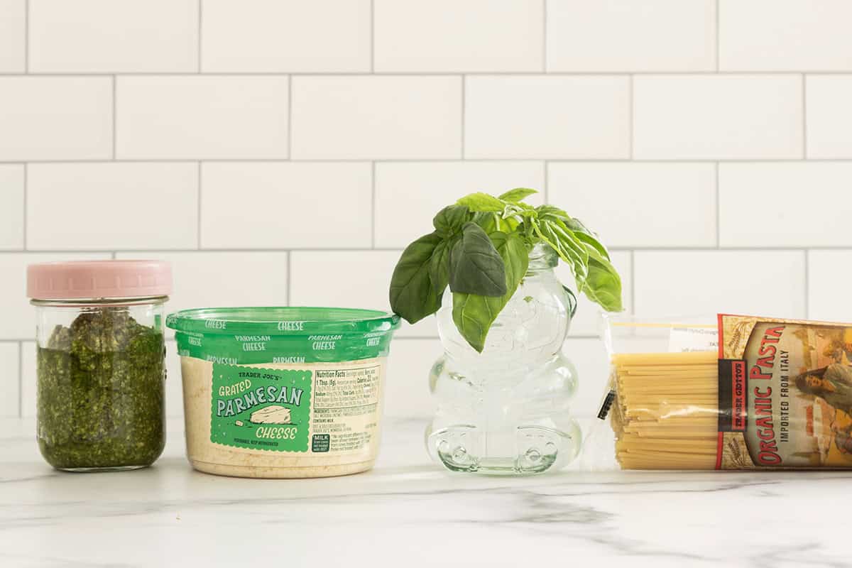 Ingredients for pesto spaghetti on countertop.