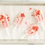 strawberry ice cream bars on parchment paper.