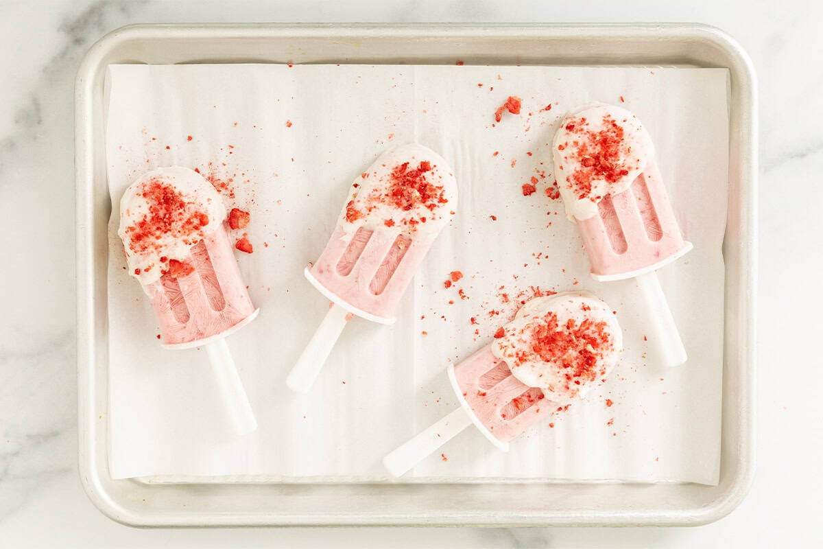 strawberry ice cream bars on parchment paper.