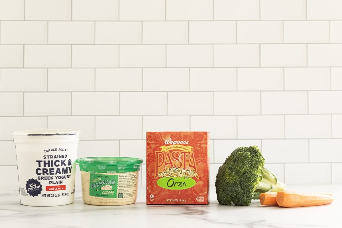 Ingredients for veggie orzo on countertop.