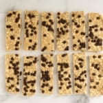 Chewy Chocolate Chip Granola Bars cut into bars on parchment paper.