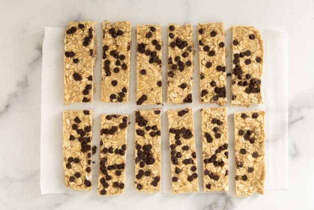 Chewy Chocolate Chip Granola Bars cut into bars on parchment paper.