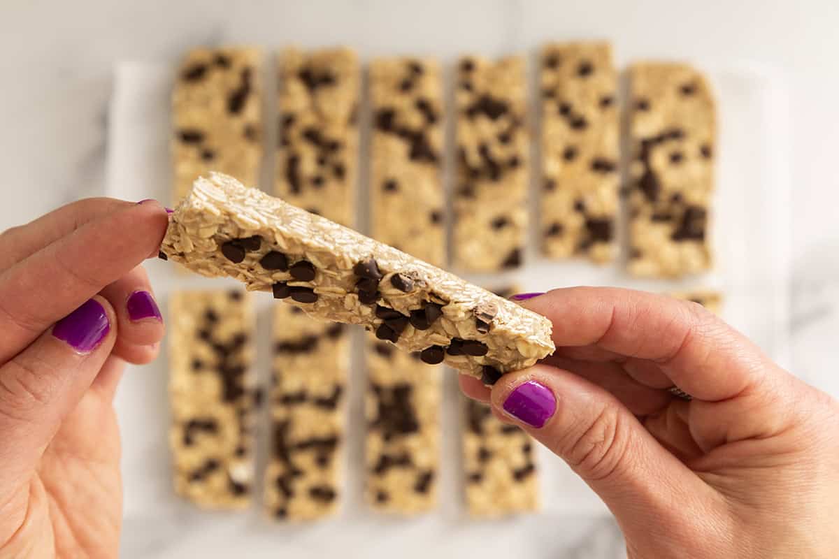 Hands holding Chewy Chocolate Chip Granola Bar.