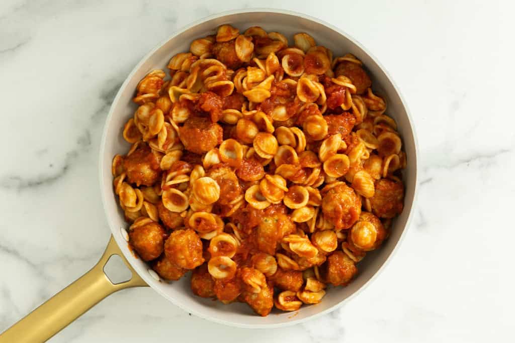 Chicken meatball pasta in pan.
