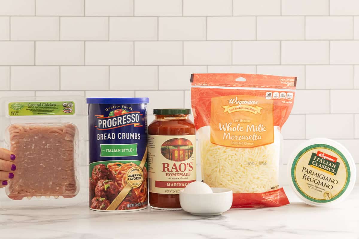 Ingredients for chicken parmesan meatballs on countertop.