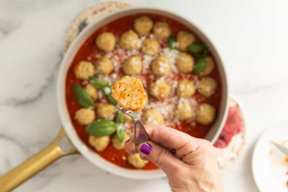 Chicken parmesan meatball on baby fork.