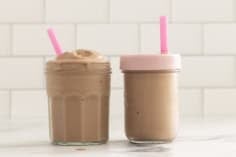 Chocolate peanut butter banana smoothie in two cups with straws.