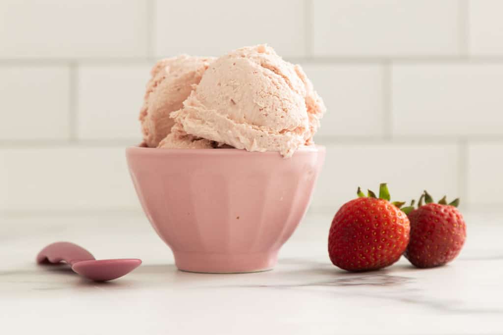 Strawberry cheesecake ice cream in pink bowl.