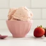 Strawberry cheesecake ice cream in pink bowl.