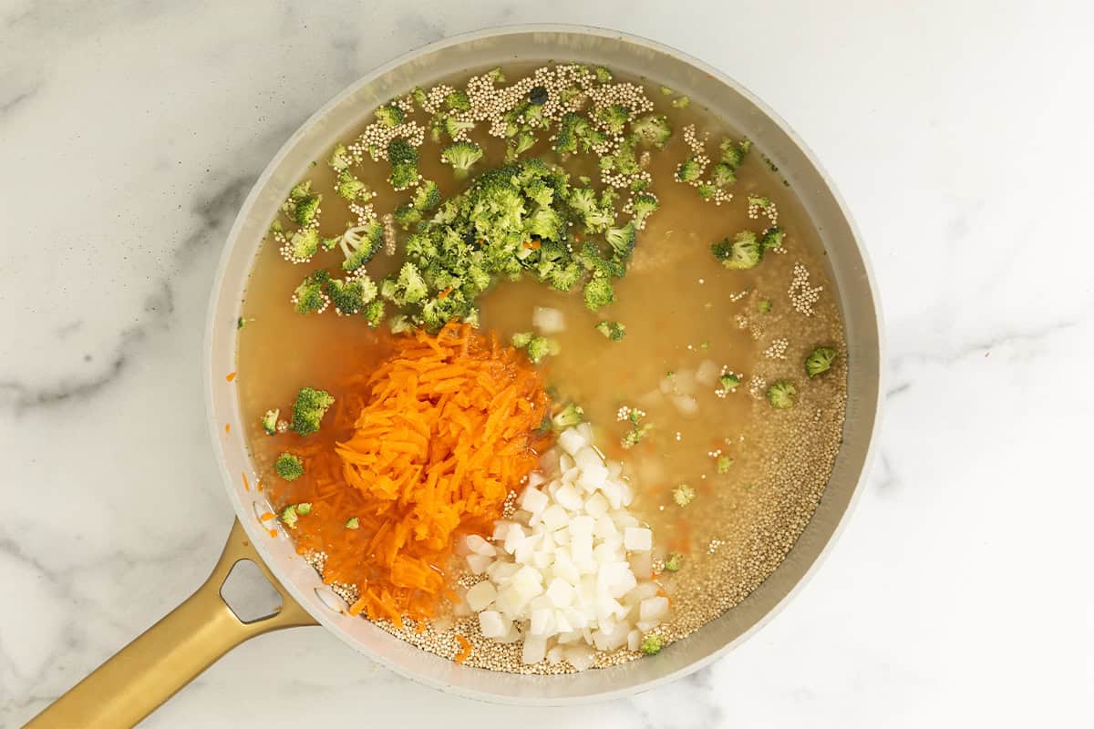 Veggies and broth in pot for veggie quinoa