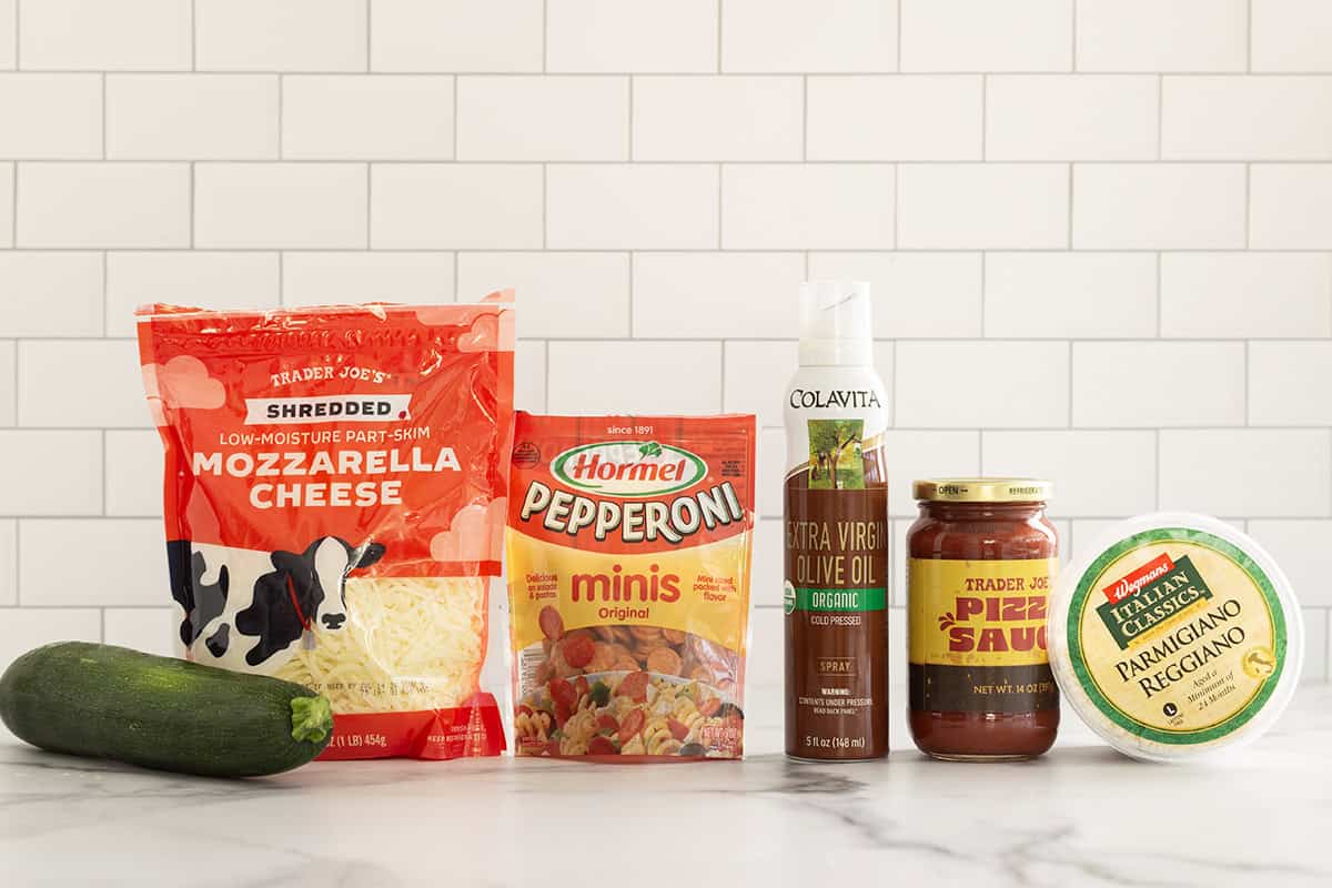 Ingredients for zucchini pizza bites on countertop.