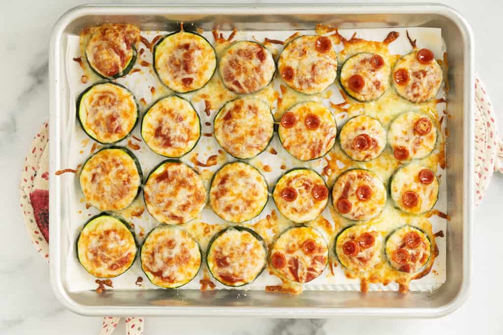 Zucchini pizza bites on baking sheet.