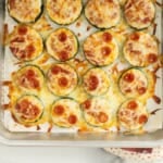 Close up of zucchini pizza bites on baking sheet.