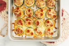 Close up of zucchini pizza bites on baking sheet.