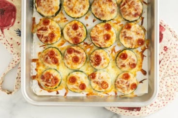 Close up of zucchini pizza bites on baking sheet.
