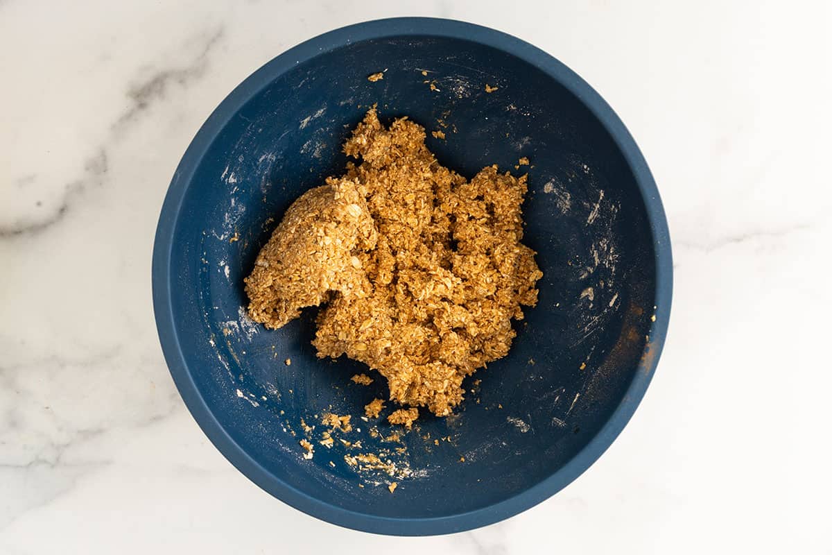 Mixture for Chewy Chocolate Chip Granola Bars in blue bowl.
