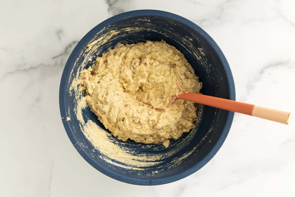 Batter for apple oatmeal cake in blue bowl.