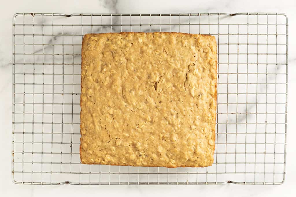 Apple oatmeal cake on cooling rack.