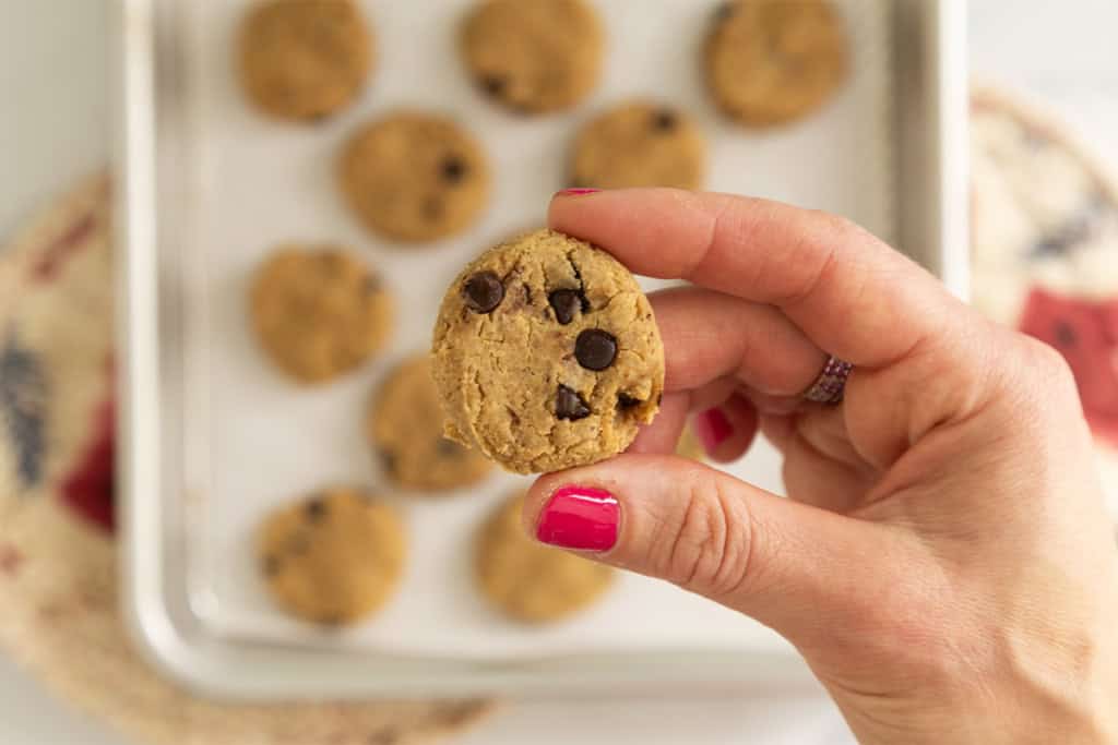 Hands holding one chickpea cookie.