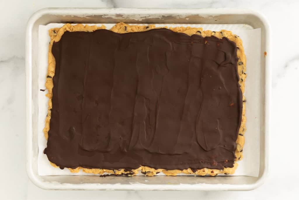 Cookie dough bark on baking sheet after freezing.