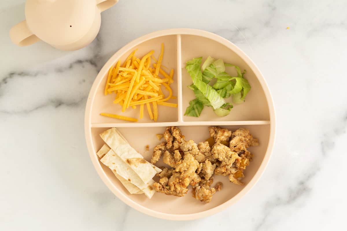 kids plate of ground chicken tacos deconstructed.