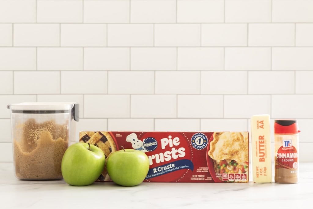 Ingredients for mini apple pies on countertop.