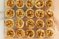 Mini apple pies on cooling rack.
