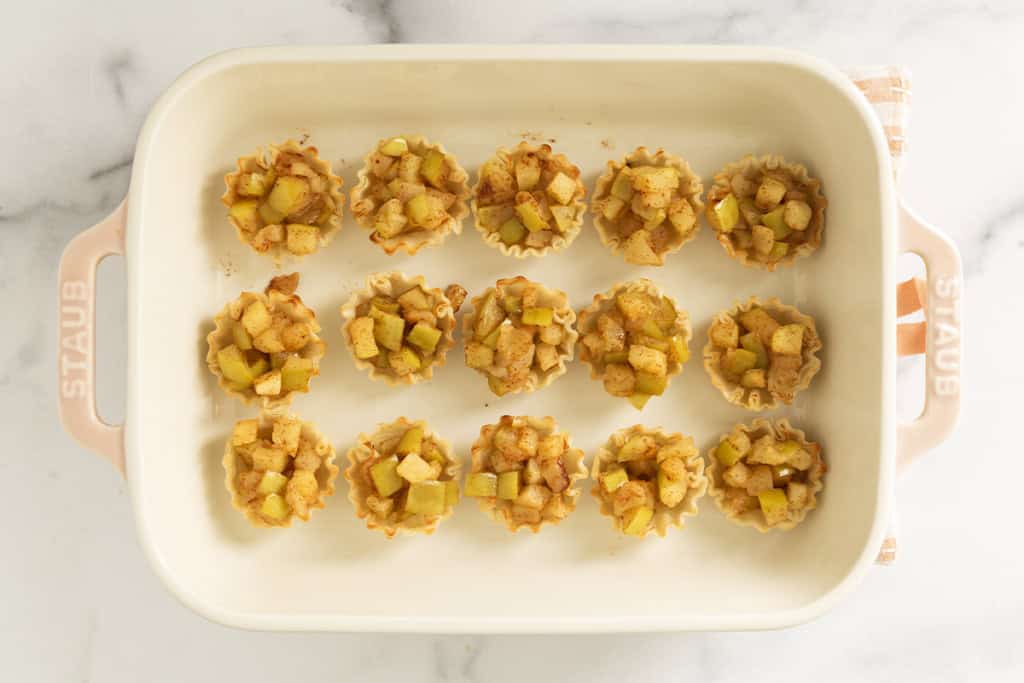 Apple pie tarts in baking pan.