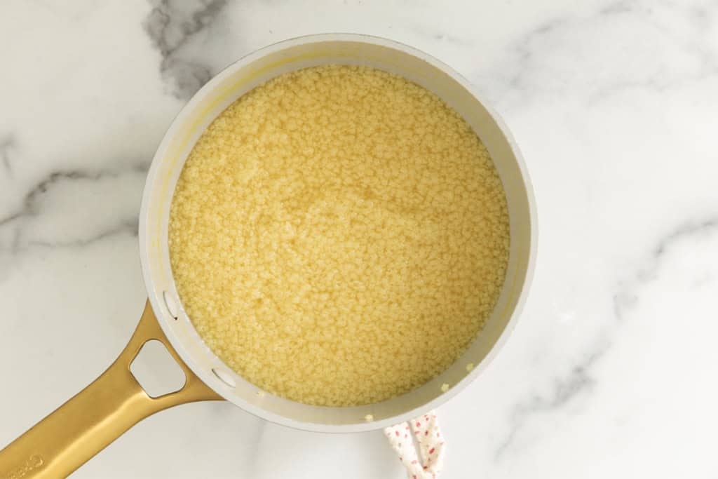 Pastina cooking in pot for pastina with egg.