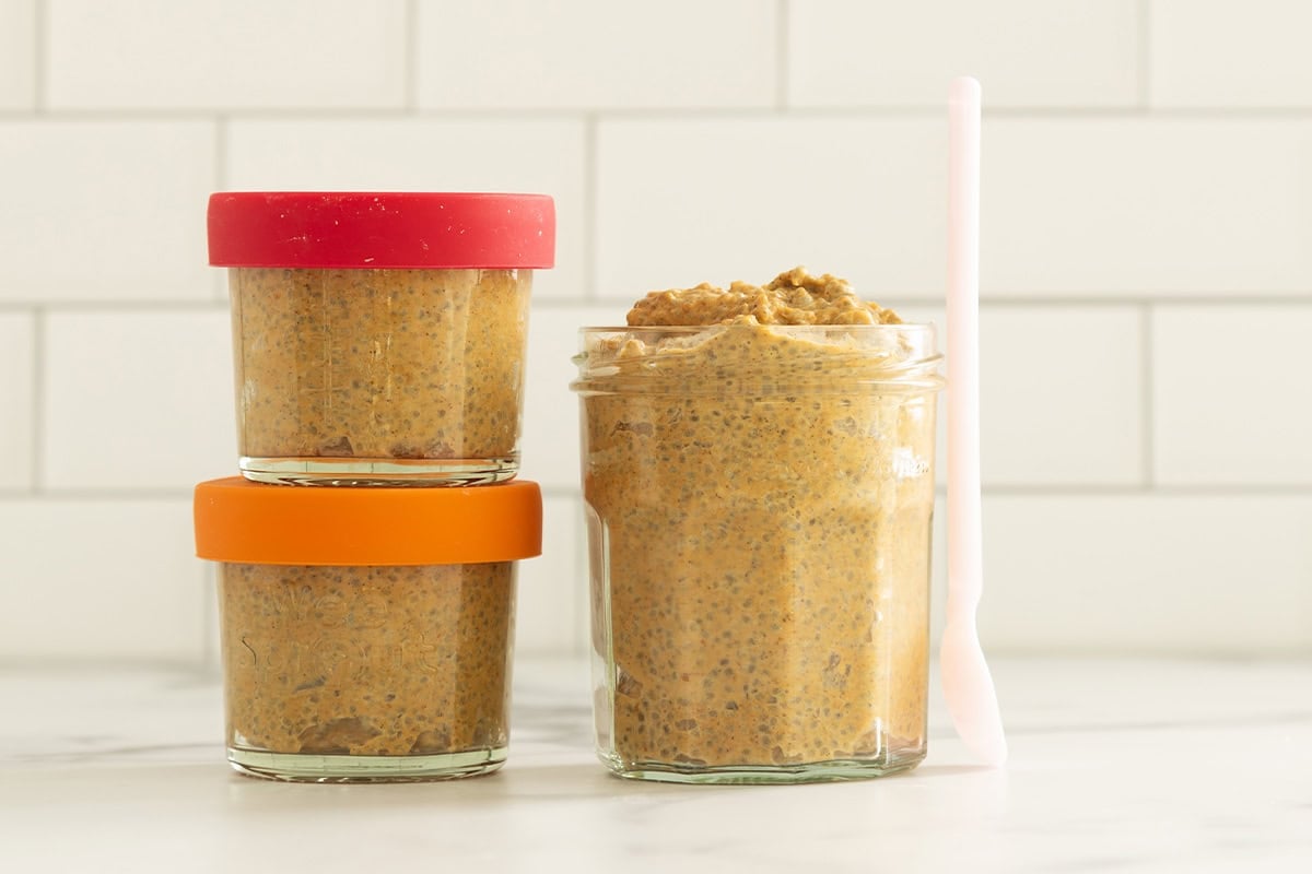 Pumpkin chia seed pudding on countertop in three glasses.
