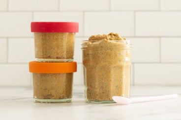 Pumpkin chia seed pudding on countertop in three glasses.