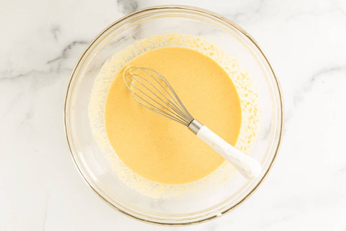 wet ingredients for pumpkin waffles in glass bowl.