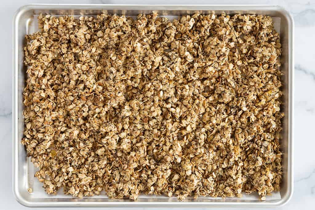 Lower sugar granola on baking sheet before baking.