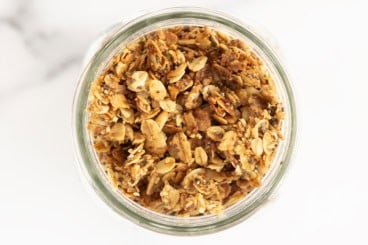 Lower sugar granola in glass jar.
