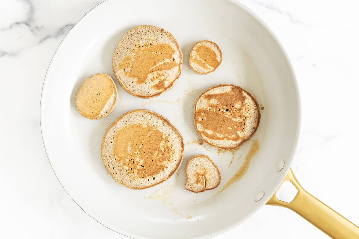 Cooked buckwheat pancakes in a skillet.