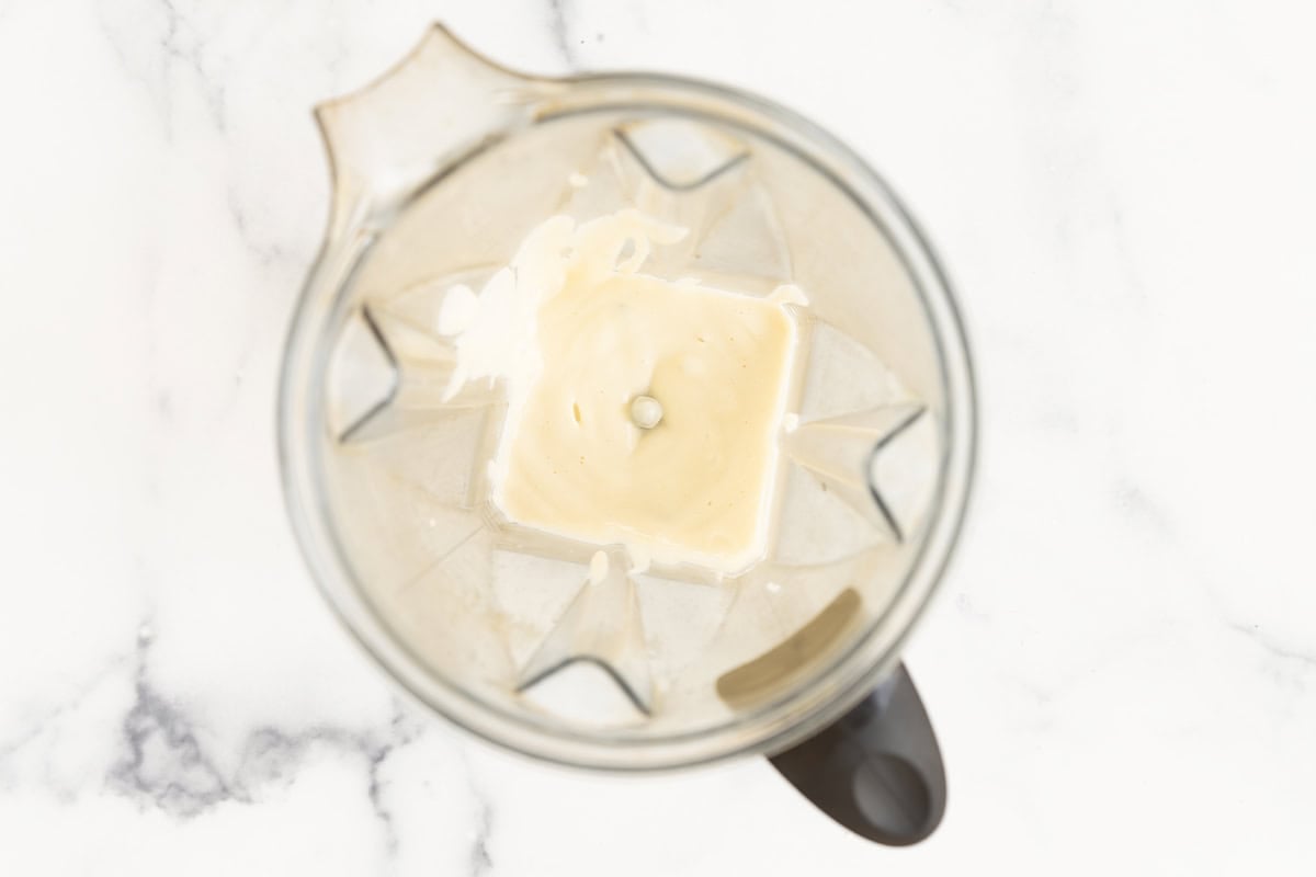 Blended cauliflower alfredo sauce in a blender.