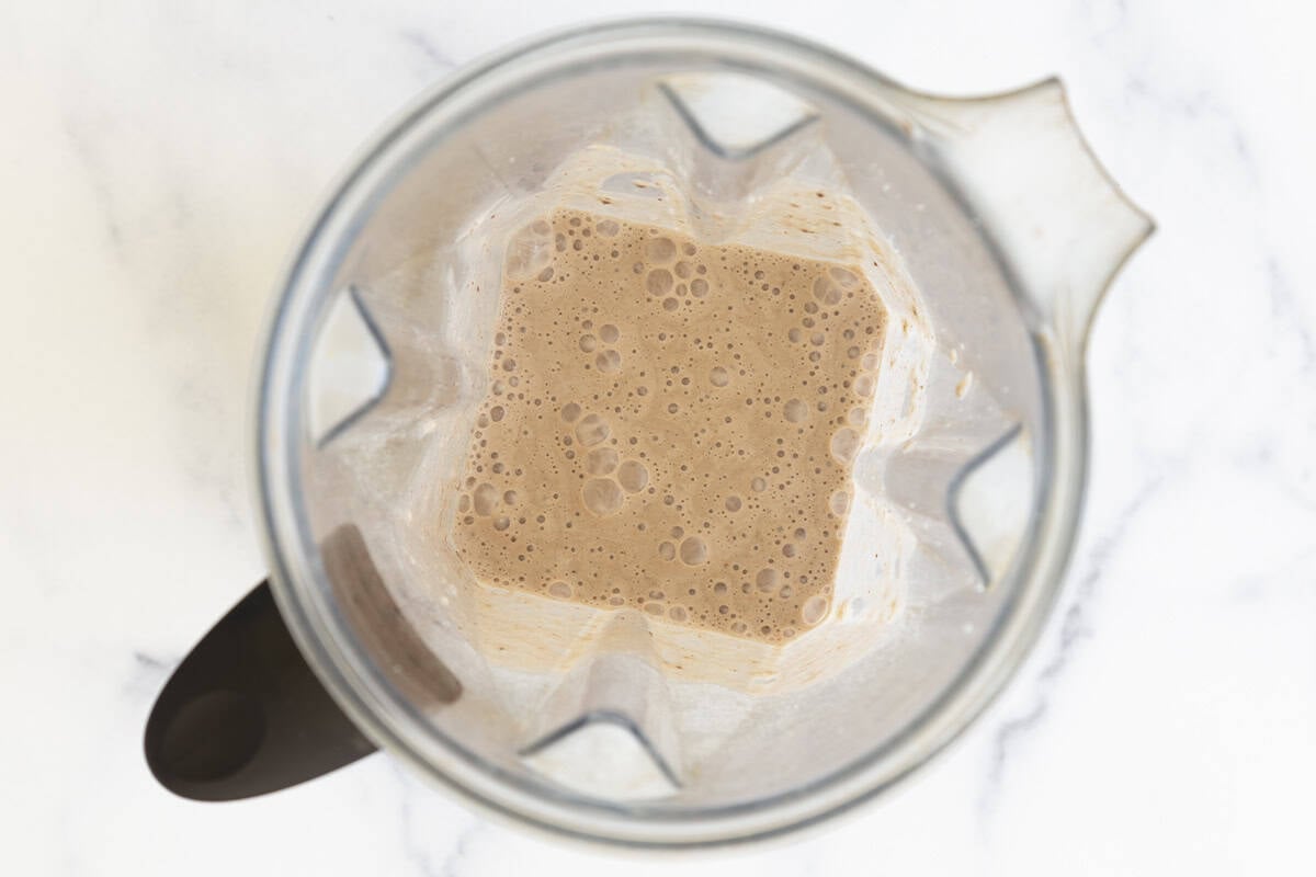Blended chocolate protein shake in a blender.