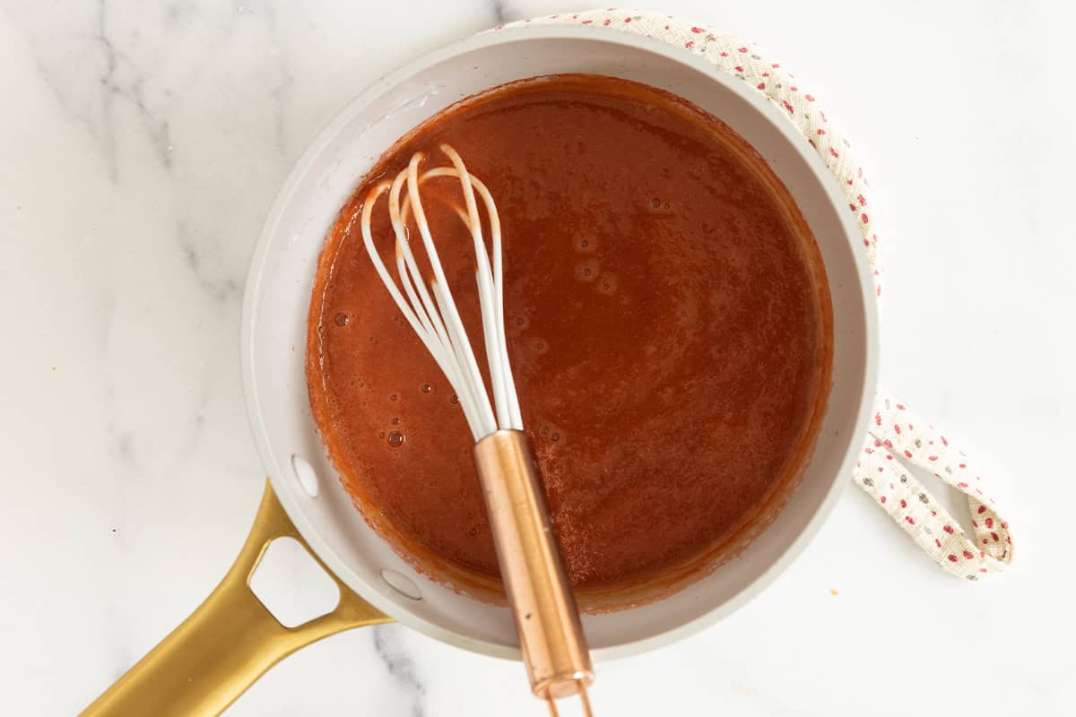 Fruit puree simmering in a saucepan.